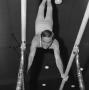 Photograph: [NTSU gymnast doing a handstand on parallel bars]