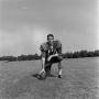 Photograph: [Football player kneeling with the ball, 37]