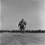Photograph: [Football player running on the field, 42]