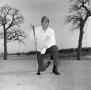 Photograph: [Unknown man kneeling while golfing]