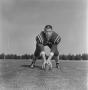 Photograph: [Football player leaning on the ball, 9]