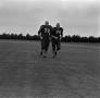 Photograph: [Two football players running]