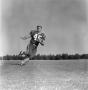 Primary view of [Football player running with an outstretched arm, 7]