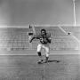 Photograph: [Football player running in his uniform, 2]