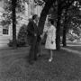 Photograph: [Two individuals posing with a tree, 5]