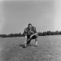 Photograph: [Football player kneeling with the ball, 34]