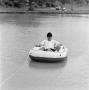 Photograph: [Man reading on a boat, 7]