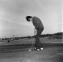 Photograph: [An unknown man about to take a putt]
