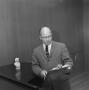 Photograph: [Dr. Kenneth Cuthbert with a clipboard]