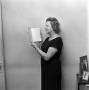 Photograph: [A woman staring at a book]