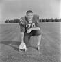 Photograph: [Football player kneeling with a helmet, 6]