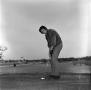 Photograph: [An unknown man about to make a putt, 3]