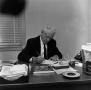 Photograph: [Dr. Dickie sitting at desk, 3 of 3]