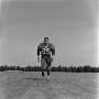 Photograph: [Football player running on the field, 43]
