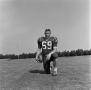 Photograph: [Football player kneeling with a ball, 17]