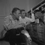 Photograph: [Two men with an opened IBM 1620]