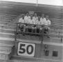 Photograph: [NTSU football coaches in the bleachers, 6]
