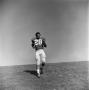Photograph: [Football player #28, David Jones, jogs to a stop]