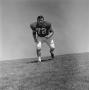 Photograph: [Football player #72, Mark Quinlan, posed in wide stance, 2]