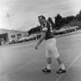 Photograph: [Football player walking in a parking lot]