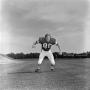 Primary view of [Football player #80, R. Hinch, running toward the camera on a flat stadium field, 2]