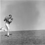 Photograph: [Football player #34, Fredrick Glynn Hachtel, running the ball]