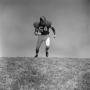 Photograph: [Football player John Pysznyski running hard down field]