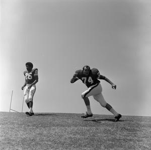 Primary view of object titled '[Football player #74 Garry Yancy and #26 Perry Pruett]'.