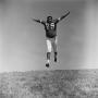 Photograph: [Football player #79, Tom Gibson, caught mid-air]