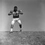 Photograph: [Football player #89 moves back with arms in a T-shape]