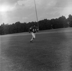 Primary view of object titled '[Football player running on the field, 61]'.