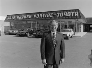 Primary view of object titled '[Man standing in front of a Pontiac-Toyota dealership, 6]'.