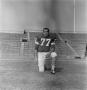 Photograph: [Football player number 77 kneeling in a football field]