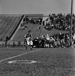 Primary view of object titled '[NTSU football players tackling WSU players, 2]'.