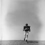 Photograph: [Football player #27, Ret Little, jogging downhill carrying a footbal…