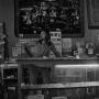Photograph: [Photograph of a store owner on Fry Street]