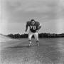 Photograph: [Football player #78 charging the camera framed by a stadium field]