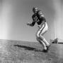 Photograph: [Football player #82, Chuck Mills, running side profile]