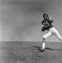 Photograph: [Football player #29, Joe Gilliam, running parallel across a field]
