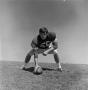 Photograph: [Football player #56, George Bray, crouched in 3 point position]