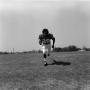 Photograph: [Football player #29, Joe Gilliam, running with a ball center frame]