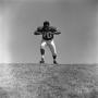 Thumbnail image of item number 1 in: '[Football player #70, Jimmy Franklin, runs forward arms in a T, 2]'.