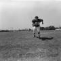 Photograph: [Football player #69 Mike Strum running to the camera over a flat gra…