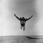 Photograph: [Football player #89, Ed Tasby, yelling mid jump tackle]