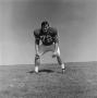 Photograph: [Football player #72, Mark Quinlan, posed in a wide stance]