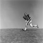 Photograph: [Football player #83, Barry Moore, positioned to catch a pass]
