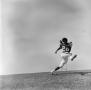 Photograph: [Football player #26, Perry Pratt, sprinting along an incline]