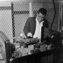 Photograph: [Dr. Bruce Foster working on a machine, 3]