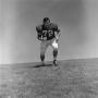 Photograph: [Football player #72, Mark Quinlan, jogging in second position]