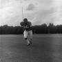 Photograph: [Football player running on the field, 63]